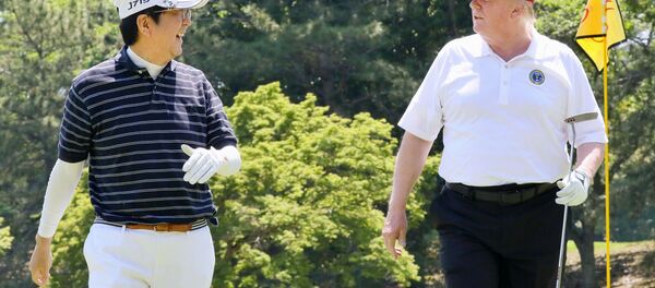 U.S. President Donald Trump talks with Japanese Prime Minister Shinzo Abe as they play golf at Mobara Country Club in Mobara, Chiba prefecture, Japan, in this photo released by Japan's Cabinet Public Relations Office via Kyodo May 26, 2019 - Sputnik International
