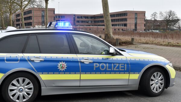 A picture taken on March 12, 2019 in Gelsenkirchen shows a German police car blocking the access to the tax office after its evacuation due to an email containing a bomb threat.  - Sputnik International