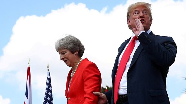 Britain's Prime Minister Theresa May and U.S. President Donald Trump walk after holding a joint news conference at Chequers, the official country residence of the Prime Minister, near Aylesbury, Britain, July 13, 2018 - Sputnik International