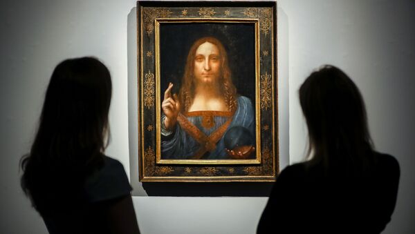 Christie's employees pose in front of a painting entitled Salvator Mundi by Italian polymath Leonardo da Vinci at a photocall at Christie's auction house in central London on October 22, 2017 ahead of its sale at Christie's New York on November 15, 2017 - Sputnik International