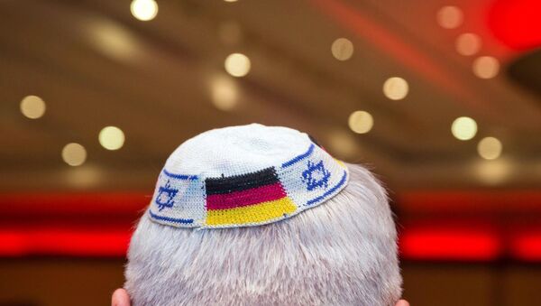 A man wearing a Jewish kippah skullcap with the flags of Germany and Israel. File photo - Sputnik International