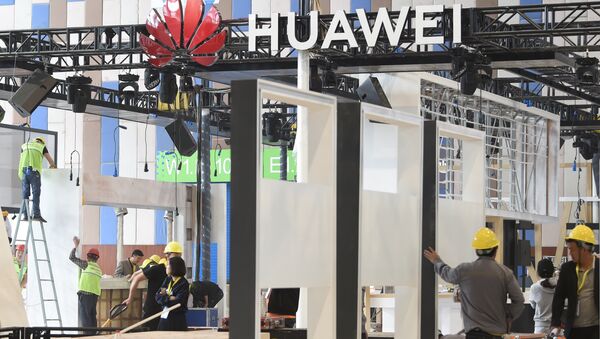 Workers are seen near the booth of Huawei Technologies, under construction at the venue of China International Big Data Industry Expo in Guiyang, Guizhou province, China 22 May 2019 - Sputnik International