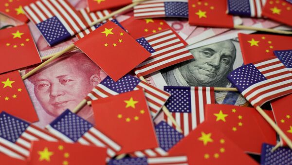 A U.S. dollar banknote featuring American founding father Benjamin Franklin and a China's yuan banknote featuring late Chinese chairman Mao Zedong among U.S. and Chinese flags in this illustration picture taken May 20, 2019. Picture taken May 20, 2019 - Sputnik International