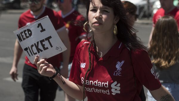 A Liverpool supporter holds a placard reading Need 1 ticket in Madrid on June 1, 2019 before the UEFA Champions League final football match between Liverpool and Tottenham Hotspur - Sputnik International