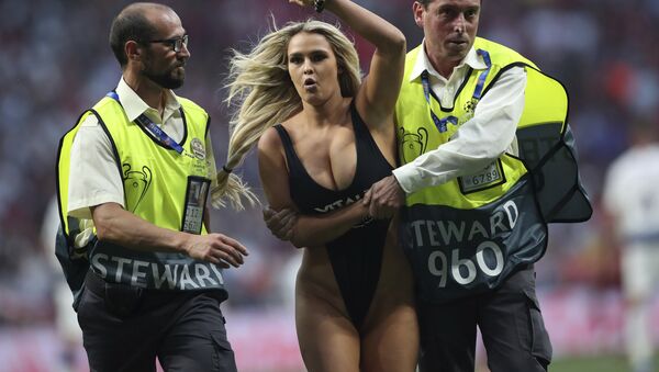 Kinsey Wolanski, a woman that has invaded the pitch is taken away by security during the Champions League final soccer match between Tottenham Hotspur and Liverpool at the Wanda Metropolitano Stadium in Madrid, Saturday, June 1, 2019. - Sputnik International