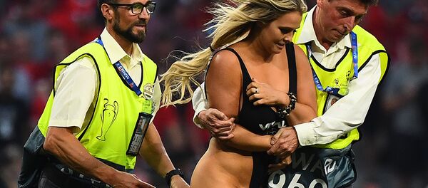Stewards escort a pitch invader during the UEFA Champions League final football match between Liverpool and Tottenham Hotspur at the Wanda Metropolitano Stadium in Madrid on June 1, 2019 - Sputnik International
