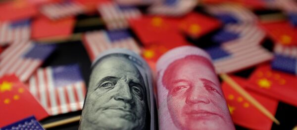 A US dollar banknote featuring American founding father Benjamin Franklin and a China's yuan banknote featuring late Chinese chairman Mao Zedong are seen among US and Chinese flags in this illustration picture taken 20 May, 2019 - Sputnik International