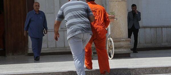 In this Sunday, May 5, 2019 photo, an IS suspect wearing a red prison suit, center right, being led to the Iraqi Criminal Court in Baghdad's Karkh district, Iraq In this Sunday, May 5, 2019 photo, an IS suspect wearing a red prison suit, center right, being led to the Iraqi Criminal Court in Baghdad's Karkh district, Iraq - Sputnik International