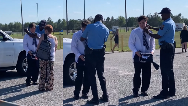 To Protect and Style? US Officer Comes to High School Grad’s Rescue - Sputnik International