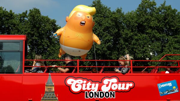  Demonstrators float a blimp portraying US President Donald Trump, behind a red tourist bus in Parliament Square, during the visit by Trump and First Lady Melania Trump in London, 13 July 2018 - Sputnik International