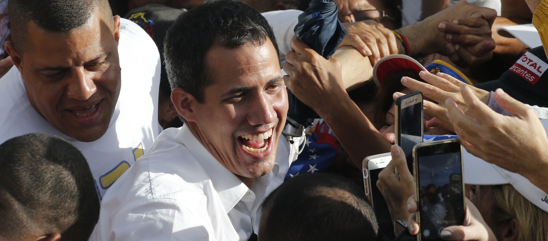 Venezuela's opposition leader and self-proclaimed interim president Juan Guaido greets supporters during a rally in Barinas, Venezuela, Saturday, June 1, 2019. Guaido is taking his campaign to oust President Nicolas Maduro to the birthplace of Hugo Chavez, the socialist leaders's mentor - Sputnik International, 1920, 25.01.2021