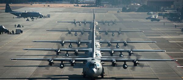 Six U.S. Air Force C-130 Hercules aircraft assigned to the 374th Airlift Wing line up before flying during a readiness week Feb. 21, 2013, at Yokota Air Base, Japan - Sputnik International