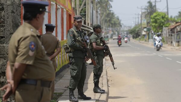 Sri Lankan army soldiers and police stand guard on a road in a Muslim neighborhood following overnight clashes in Poruthota, a village in Negombo, about 35 kilometers North of Colombo, Sri Lanka, Monday, May 6, 2019 - Sputnik International