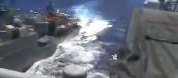 In this image released by the US Navy on June 7, 2019, the Russian anti-submarine ship Admiral Vinogradov (L) sails close to the USS Chancellorsville In this image released by the US Navy on June 7, 2019, the Russian anti-submarine ship Admiral Vinogradov (L) sails close to the USS Chancellorsville - Sputnik International