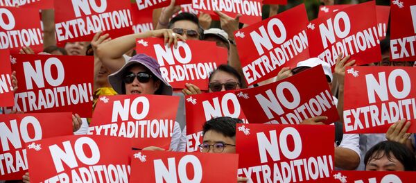 Protesters hold placards as they stage protest against the extradition law in Hong Kong, Sunday, June 9, 2019 - Sputnik International