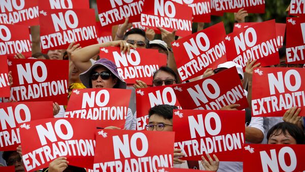 Protesters hold placards as they stage protest against the extradition law in Hong Kong, Sunday, June 9, 2019 - Sputnik International