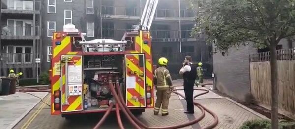 Dozens of firefighters were called to the scene on Sunday as a fire broke out at a new apartment block in the east of the British capital - Sputnik International