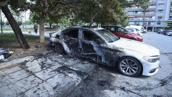 A damaged car belonging to a Turkish national is parked by a block of flats in the northern port city of Thessaloniki, Greece on Monday, June 10, 2019 - Sputnik International