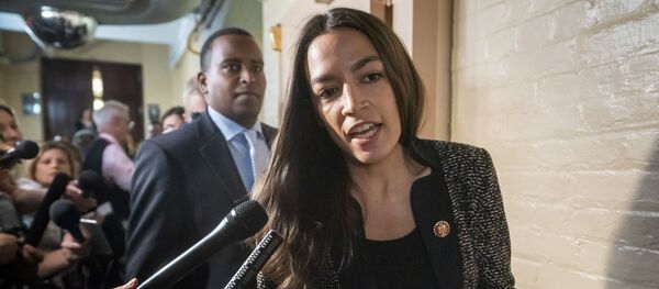 Rep. Alexandria Ocasio-Cortez, D-N.Y., followed by Rep. Joe Neguse, D-Colo., responds to reporters' questions after Speaker of the House Nancy Pelosi, D-Calif., met with all the House Democrats, many calling for impeachment proceedings against President Donald Trump after his latest defiance of Congress by blocking his former White House lawyer from testifying yesterday, at the Capitol in Washington, Wednesday, May 22, 2019 - Sputnik International