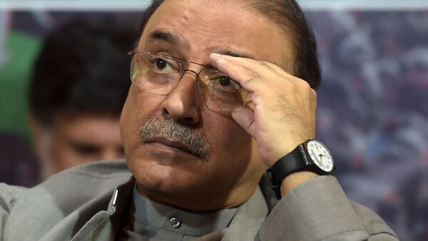 Former Pakistani president Asif Ali Zardari listens to his son and chairman of the Pakistan Peoples Party (PPP) Bilawal Bhutto Zardari (unseen) during the party manifesto presentation for the forthcoming general election during a press conference in Islamabad on June 28, 2018 - Sputnik International