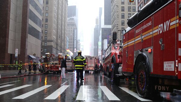 New York City Fire Department trucks and firefighters are seen outside 787 7th Avenue in midtown Manhattan where a helicopter was reported to have crashed in New York City, New York, U.S., June 10, 2019. REUTERS/Brendan McDermid - Sputnik International