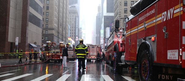 New York City Fire Department trucks and firefighters are seen outside 787 7th Avenue in midtown Manhattan where a helicopter was reported to have crashed in New York City, New York, U.S., June 10, 2019. REUTERS/Brendan McDermid New York City Fire Department trucks and firefighters are seen outside 787 7th Avenue in midtown Manhattan where a helicopter was reported to have crashed in New York City, New York, U.S., June 10, 2019. REUTERS/Brendan McDermid - Sputnik International