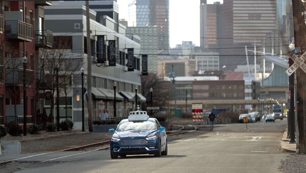 In this Dec. 18, 2018, photo one of the test vehicles from Argo AI, Ford's autonomous vehicle unit, navigates through the strip district near the company offices in Pittsburgh - Sputnik International