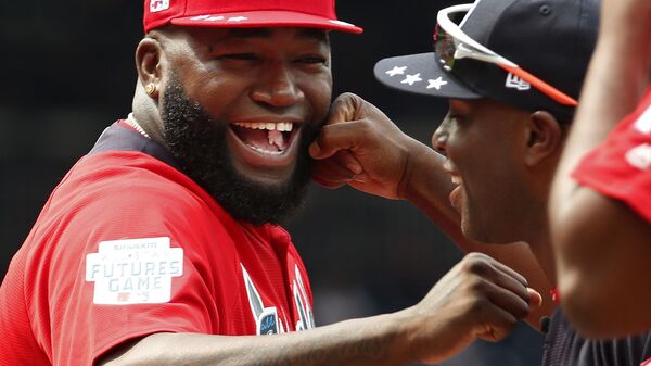 In this July 15, 2018, file photo, World Team Manager David Ortiz (34) speaks with U.S. Team Manager Torrii Hunter, before the All-Star Futures baseball game at Nationals Park, in Washington. Ortiz returned to Boston for medical care after being shot in a bar Sunday, June 9, 2019, in his native Dominican Republic.  - Sputnik International