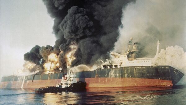 The Singapore registered tanker Norman Atlantic sits ablaze in the Straits of Hormuz on Dec. 6, 1987, after being attacked by an Iranian gunboat. The 86,129 ton tanker was carrying a cargo of naphtha liquid gas from Kuwait. All 22 crewmen left the ship and no injuries were reported. - Sputnik International