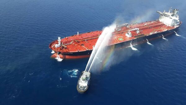 An Iranian navy boat tries to stop the fire of an oil tanker after it was attacked in the Gulf of Oman, June 13, 2019 - Sputnik International
