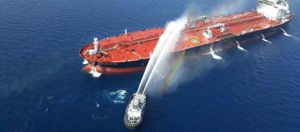 An Iranian navy boat tries to stop the fire of an oil tanker after it was attacked in the Gulf of Oman, June 13, 2019 - Sputnik International