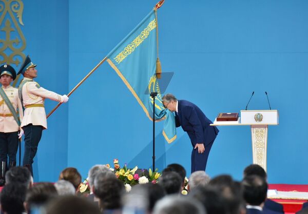 Kazakh President Kassym-Jomart Tokayev kisses the state flag during his inauguration ceremony in Nur-Sultan, Kazakhstan. - Sputnik International