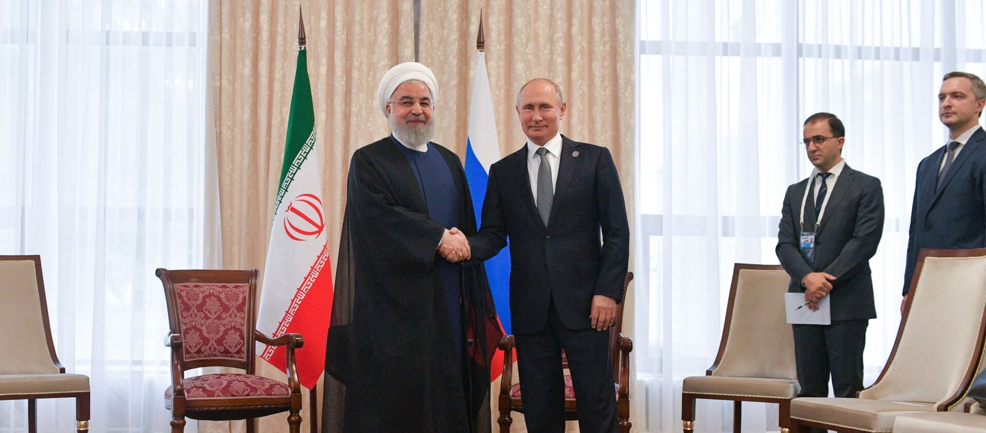 Russian President Vladimir Putin shakes hands with Iranian President Hassan Rouhani, left, during their meeting at the Shanghai Cooperation Organization (SCO) summit, in Bishkek, Kyrgyzstan - Sputnik International, 1920, 18.07.2019