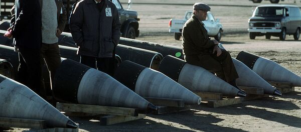 Soviet inspectors and their American escorts stand among several dismantled Pershing II missiles as they view the destruction of other missile components Soviet inspectors and their American escorts stand among several dismantled Pershing II missiles as they view the destruction of other missile components - Sputnik International