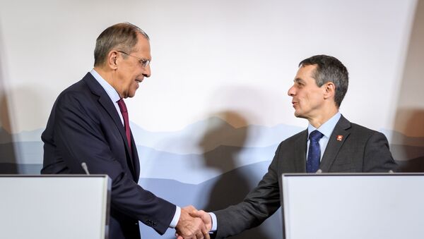 Russian Foreign Minister Sergei Lavrov (L) shakes hands with Swiss Foreign Minister Ignazio Cassis  - Sputnik International