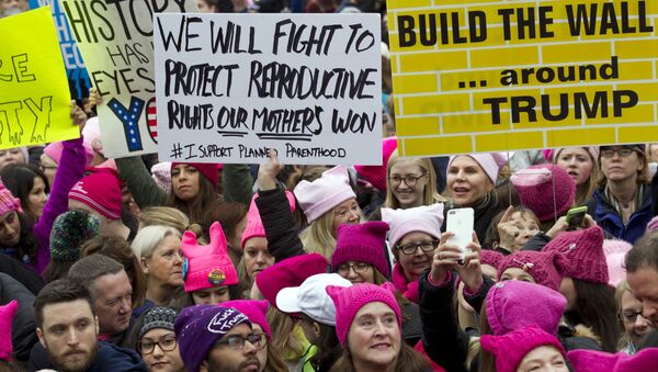 Women with bright pink hats and signs begin to gather early and are set to make their voices heard on the first full day of Donald Trump's presidency, in Washington.  - Sputnik International