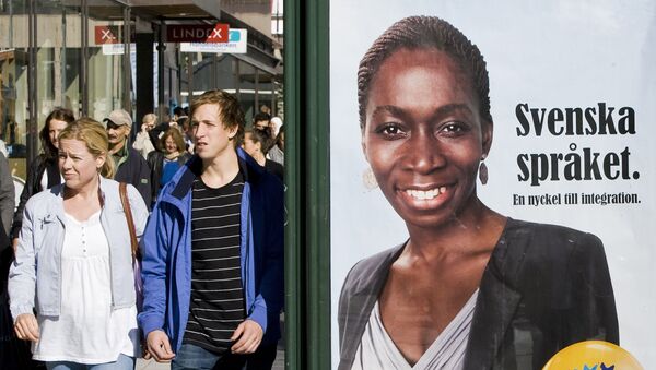 Swedish people walk next to an election poster of Nyamko Sabuni from The Liberal People's Party, a central-right which advocates social liberalismin central Stockholm on September 9, 2010 ahead of the September 19 elections - Sputnik International