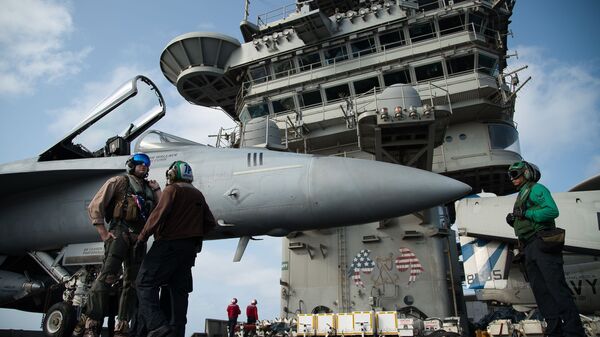 FILE - In this June 3, 2019 file photo, a pilot speaks to a crew member by an F/A-18 fighter jet on the deck of the USS Abraham Lincoln aircraft carrier in the Arabian Sea - Sputnik International