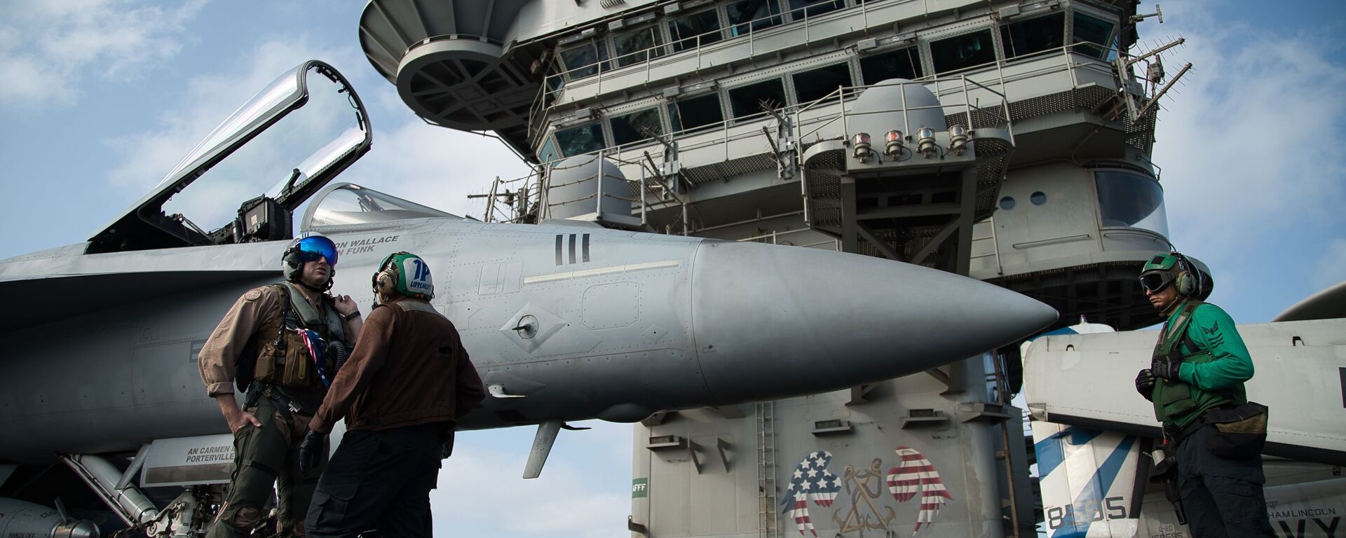 FILE - In this June 3, 2019 file photo, a pilot speaks to a crew member by an F/A-18 fighter jet on the deck of the USS Abraham Lincoln aircraft carrier in the Arabian Sea - Sputnik International, 1920, 08.08.2024