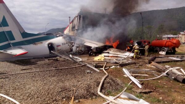 An Antonov An-24 passenger plane is seen on fire after an emergency landing in the town of Nizhneangarsk, Russia June 27, 2019 - Sputnik International