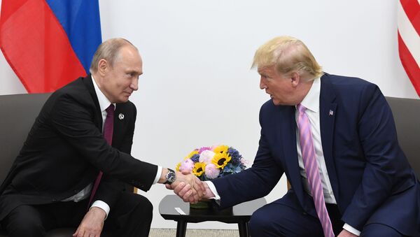 Russian President Vladimir Putin and U.S. President Donald Trump shake hands during a bilateral meeting at the at the Group of 20 (G20) leaders summit in Osaka, Japan. - Sputnik International