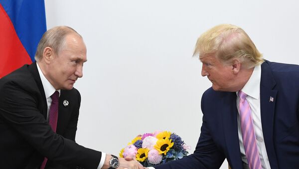 Russian President Vladimir Putin and U.S. President Donald Trump shake hands during a bilateral meeting at the at the Group of 20 (G20) leaders summit in Osaka, Japan. - Sputnik International