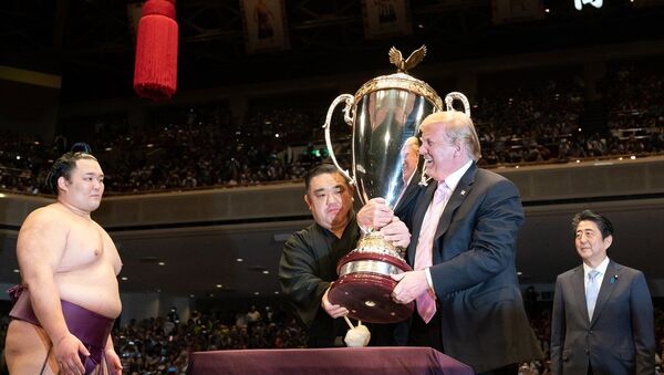 US President Donald Trump and Japan's Prime Minister Shinzo Abe attend the Sumo Grand Championship, where Trump participates in the presentation of trophies at Ryōgoku Kokugikan Stadium in Tokyo on 27 May 2019 - Sputnik International