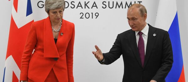 British Prime Minister Theresa May and Russian President Vladimir Putin take their seats during a meeting on the sidelines of the Group of 20 (G20) leaders summit in Osaka, Japan - Sputnik International