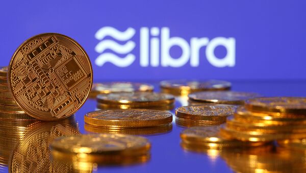  Representations of virtual currency are displayed in front of the Libra logo in this illustration picture, June 21, 2019 - Sputnik International
