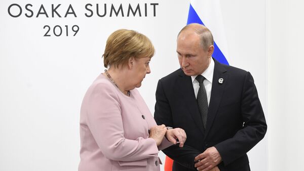 Russian President Vladimir Putin met with German Chancellor Angela Merkel earlier in the day on the sidelines of the G20 summit in Isaka, Japan. - Sputnik International