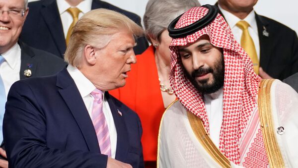 U.S. President Donald Trump speaks with Saudi Arabia's Crown Prince Mohammed bin Salman during family photo session with other leaders and attendees at the G20 leaders summit in Osaka, Japan, June 28, 2019.  - Sputnik International