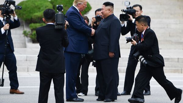 North Korea's leader Kim Jong Un shakes hands with US President Donald Trump north of the Military Demarcation Line that divides North and South Korea, in the Joint Security Area (JSA) of Panmunjom in the Demilitarized zone (DMZ) on June 30, 2019.  - Sputnik International