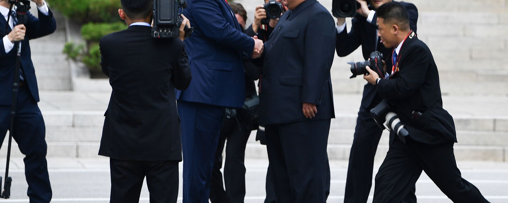 North Korea's leader Kim Jong Un shakes hands with US President Donald Trump north of the Military Demarcation Line that divides North and South Korea, in the Joint Security Area (JSA) of Panmunjom in the Demilitarized zone (DMZ) on June 30, 2019.  - Sputnik International, 1920, 30.06.2019
