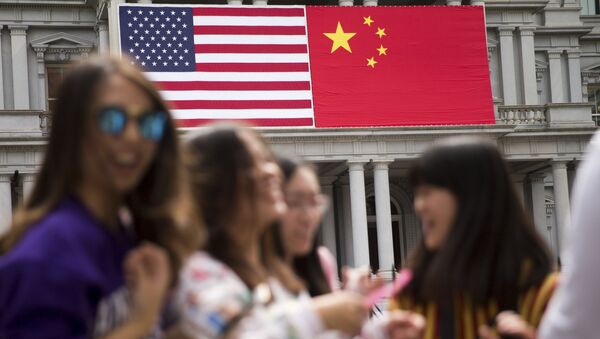 In this Thursday, Sept. 24, 2015, photo, China's flag is displayed next to the American flag on the side of the Old Executive Office Building on the White House complex in Washington, the day before a state visit by Chinese President Xi Jinping - Sputnik International